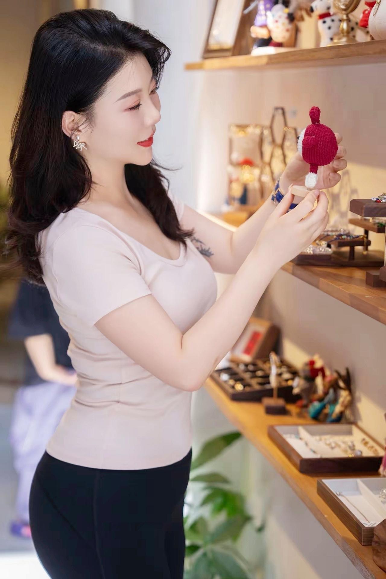 《雅姿映光》粉衫裁软衬身姿，黑裤凝光映雅姿。金饰轻垂添秀色，庭前光影入眉