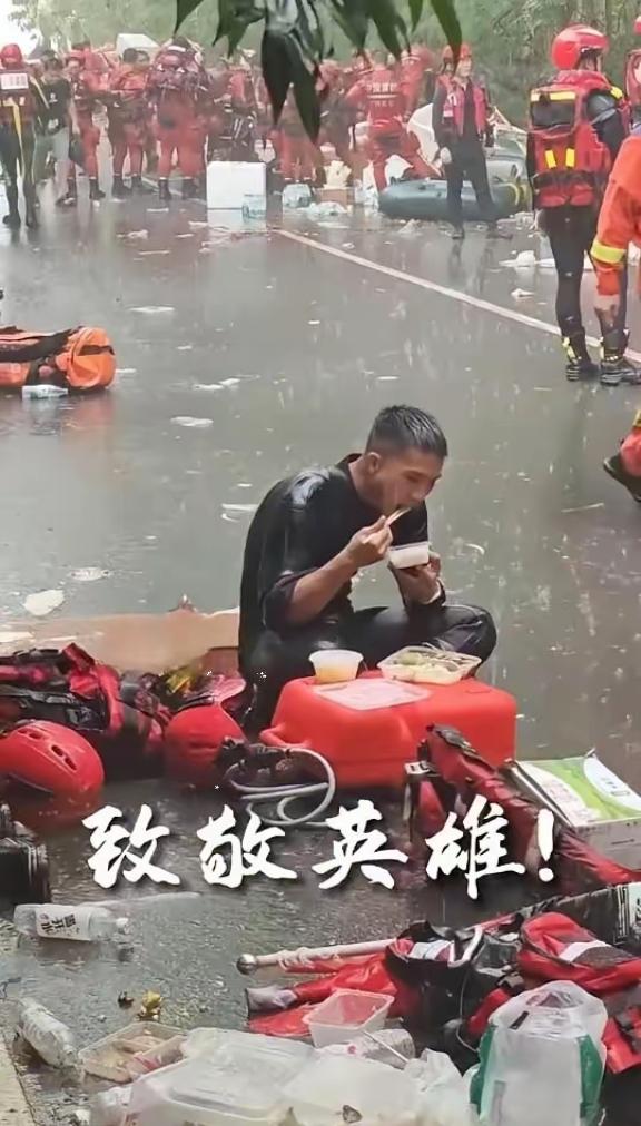 恕我直言！这张照片最戳人的不是雨中吃饭。而是不远处明明支着帐篷几步路就到，他