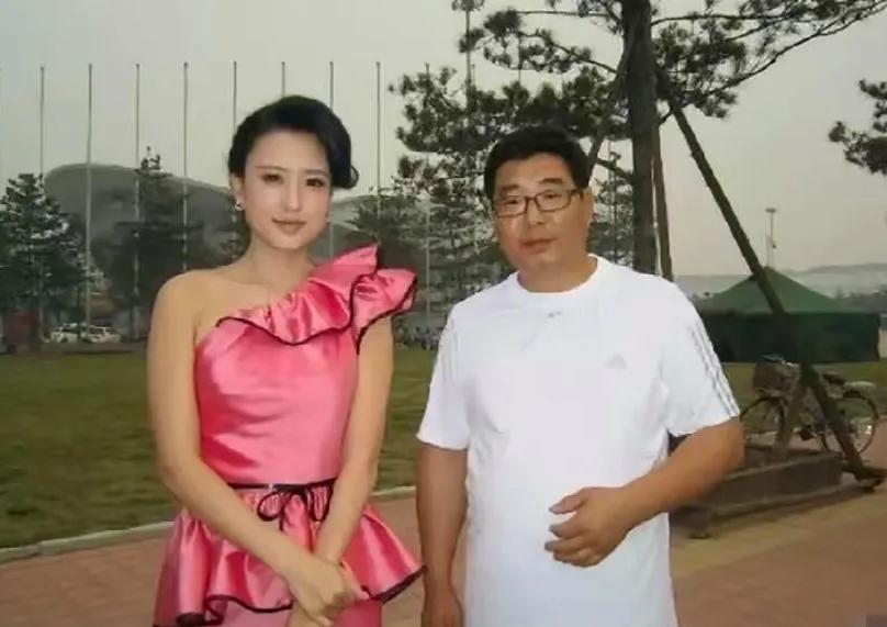 画面中的张蕾身材傲人，粉妆玉琢，目若朗星，琼鼻秀挺，光莹娇媚，玉貌珠辉；身边的老