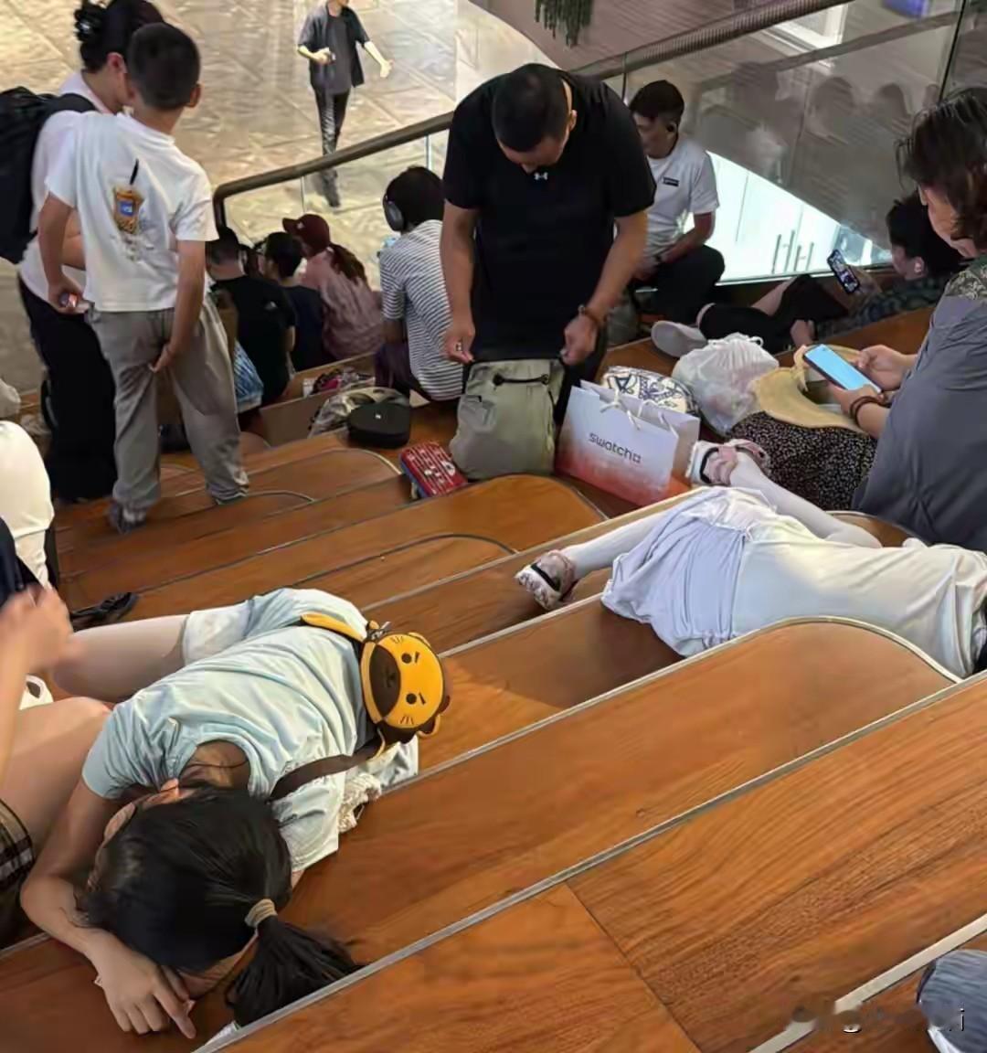 游客在香港商场坐地上蹭空调，被香港网友发网上指责，有人说菲佣在天桥、公园、街边的