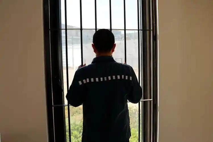 笑话（761）贪官被判刑后在监狱里就像丢了魂似的，每天手扶着铁窗望着窗外出神