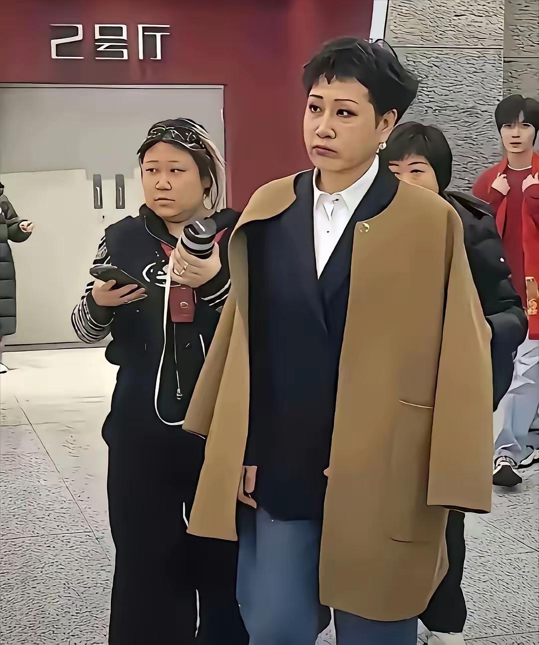 这位老奶奶你们认识吗？她是不是整容了，怪吓人的，她披着风衣，给人一种感觉就是实