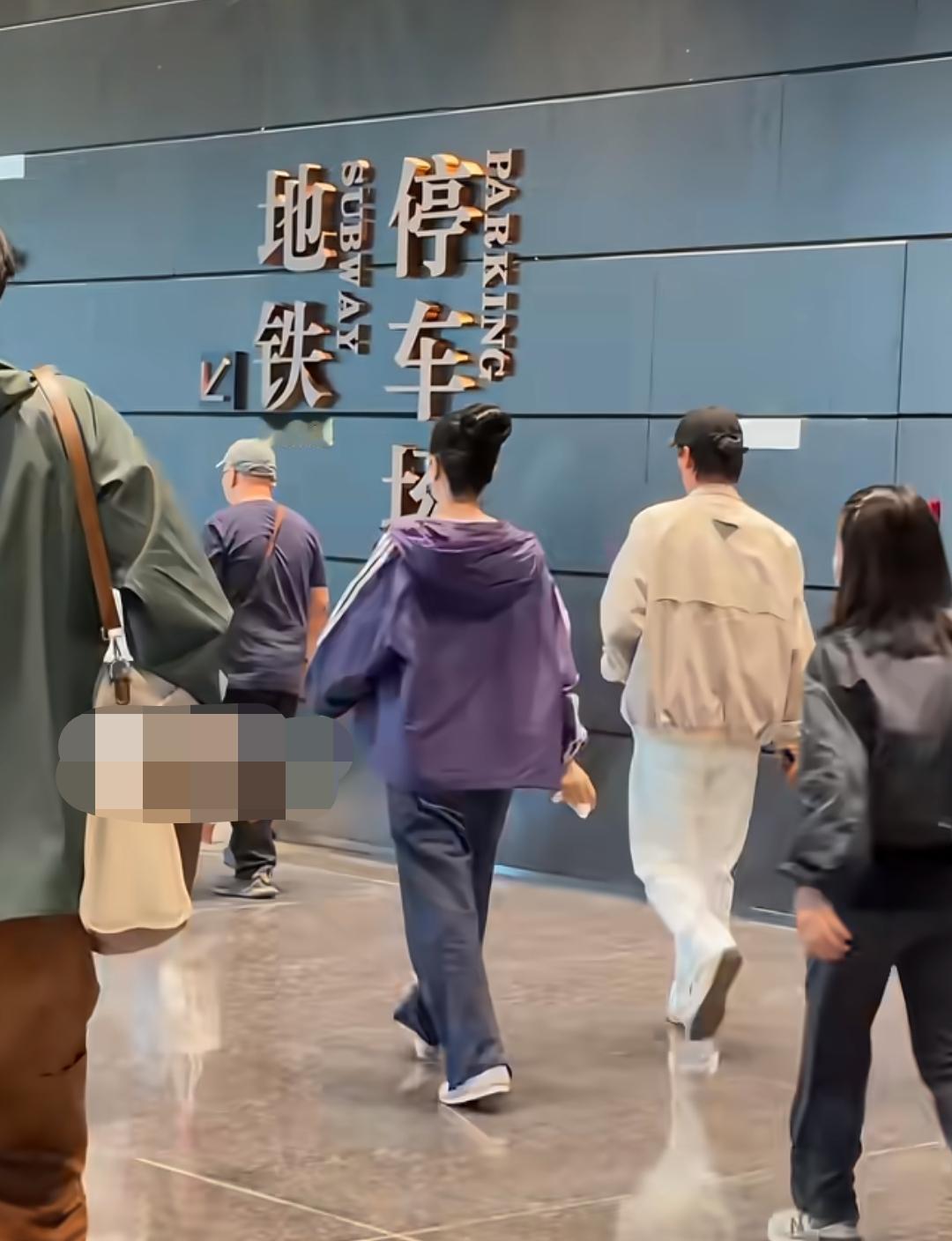 网友在地铁停车场偶遇王菲，就拿着手机对着王菲一行人“咔咔”一顿拍，王菲身边的工作