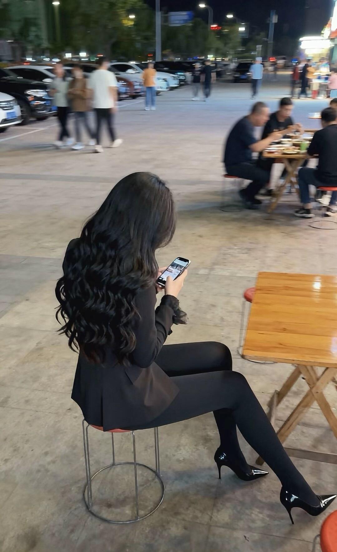 夜晚的街角，独自一人，手机相伴，享受宁静时光。