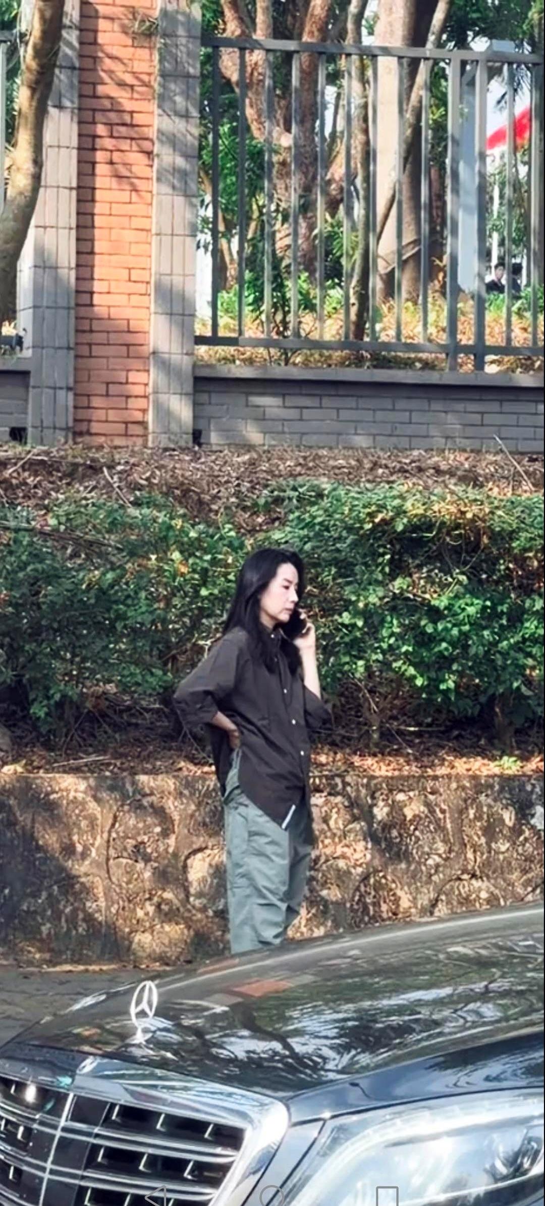 董洁路边打电话，画面仿佛把镜头贴在日常细节上。身形消瘦、皮肤白皙，木偶纹清晰，