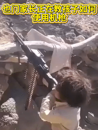 也门一名男子正在教他的孩子操作机枪射击？这么小的孩子射击时却从容不迫，一点都不