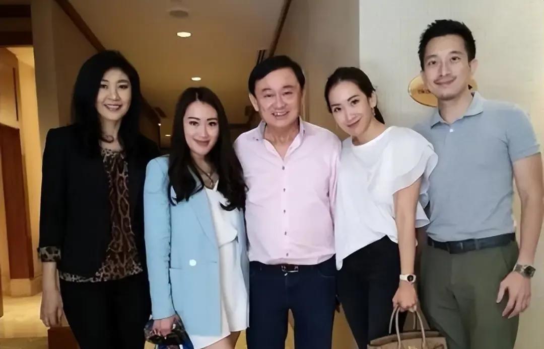他信家族是第四代华裔，曾祖父是广东梅州人，因战乱逃到了泰国，由于无法适应当地气候