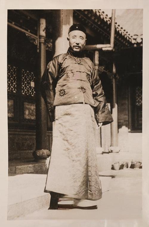 1922年，张作霖生活照，他身着传统中式长袍马褂，深色衣料上绣有素雅花纹，搭配浅