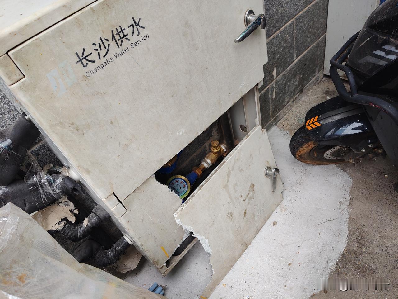 笔者今日进出长沙某小区，在小区大门口发现才安装不久的水表箱竟然有一扇门破损，有一
