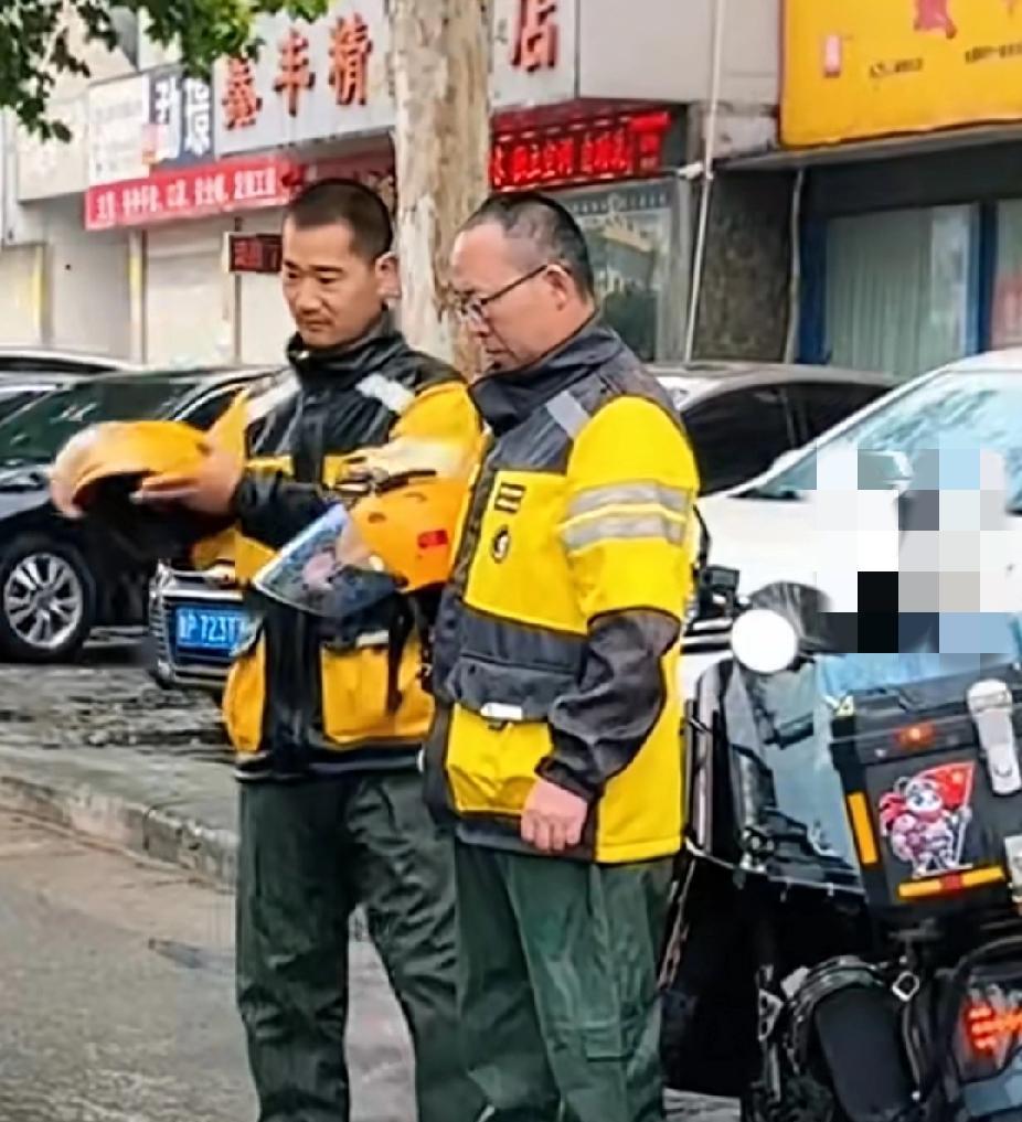 9月18日，河南长葛上空响起防空警报，一名外卖小哥立马靠边停车脱下头盔，雨中低头