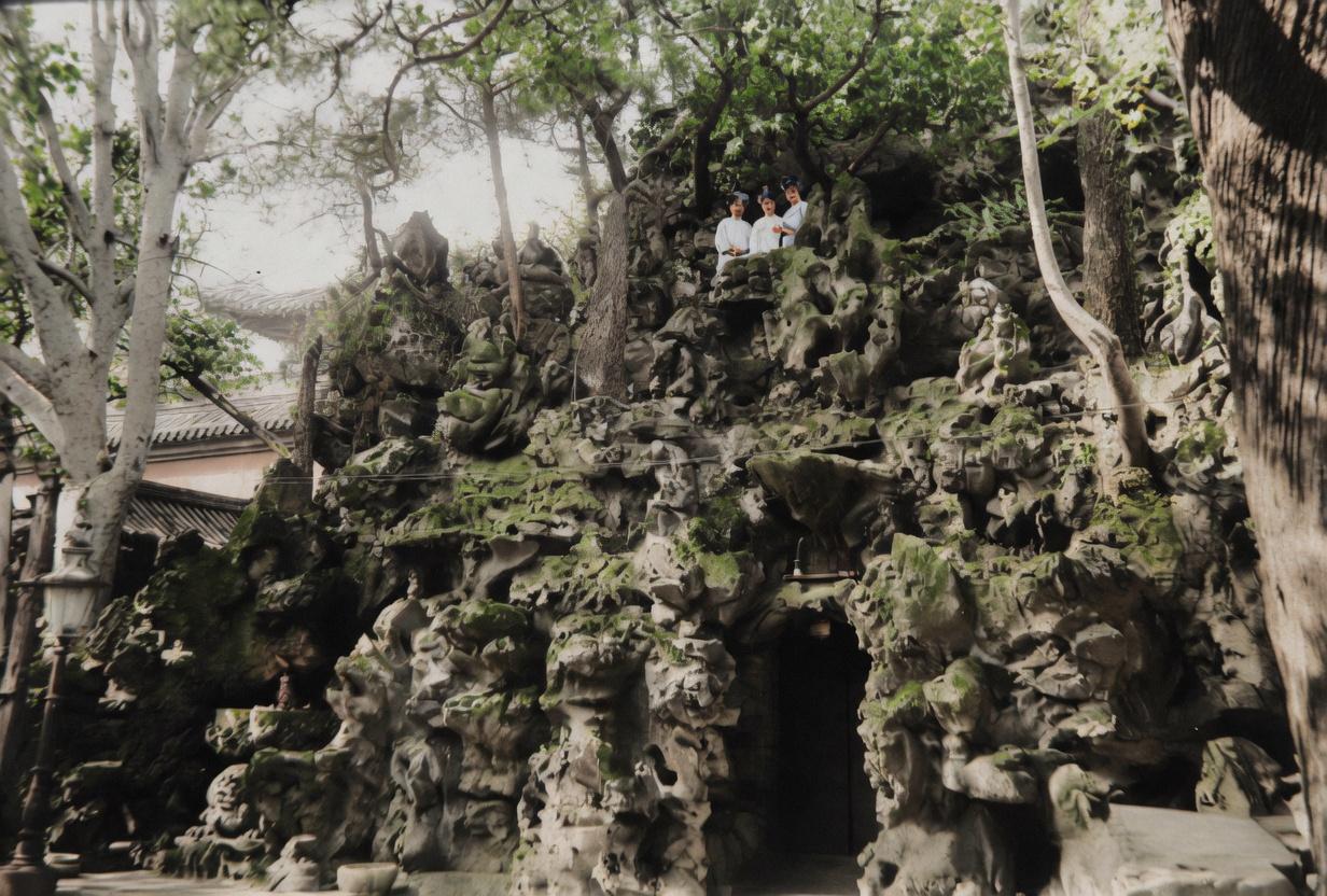 逊清小朝廷时期，紫禁城御花园，婉容、文秀与唐怡莹，坐在太湖石假山上留影。三人姿