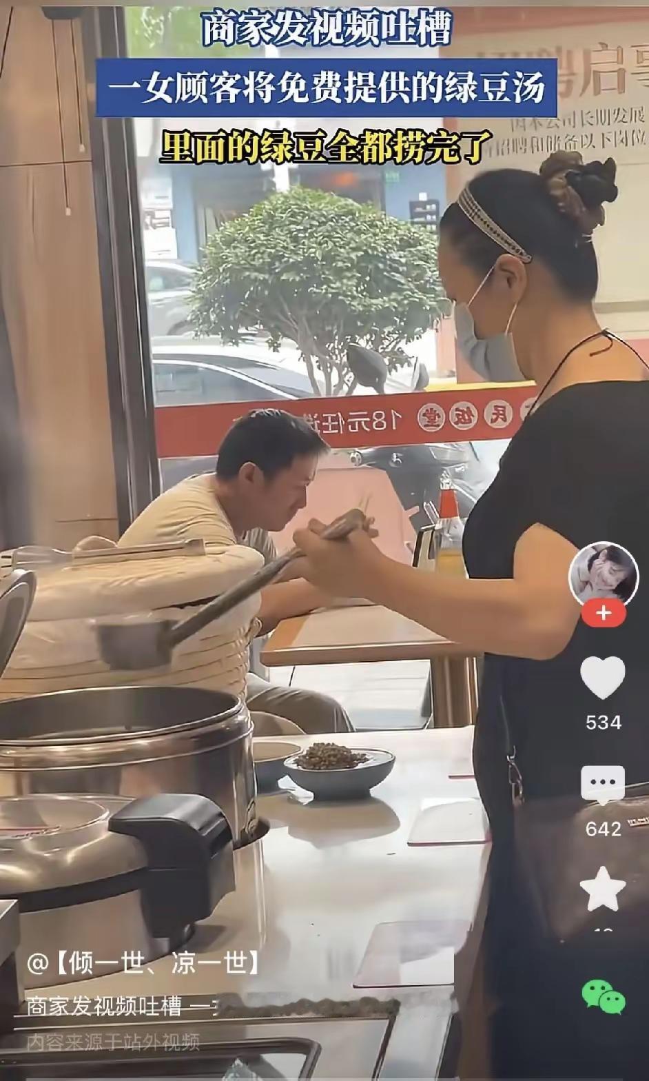 山东一家社区快餐店。店家熬两大锅绿豆汤免费供应，一女顾客打完菜，走到汤锅边，盛