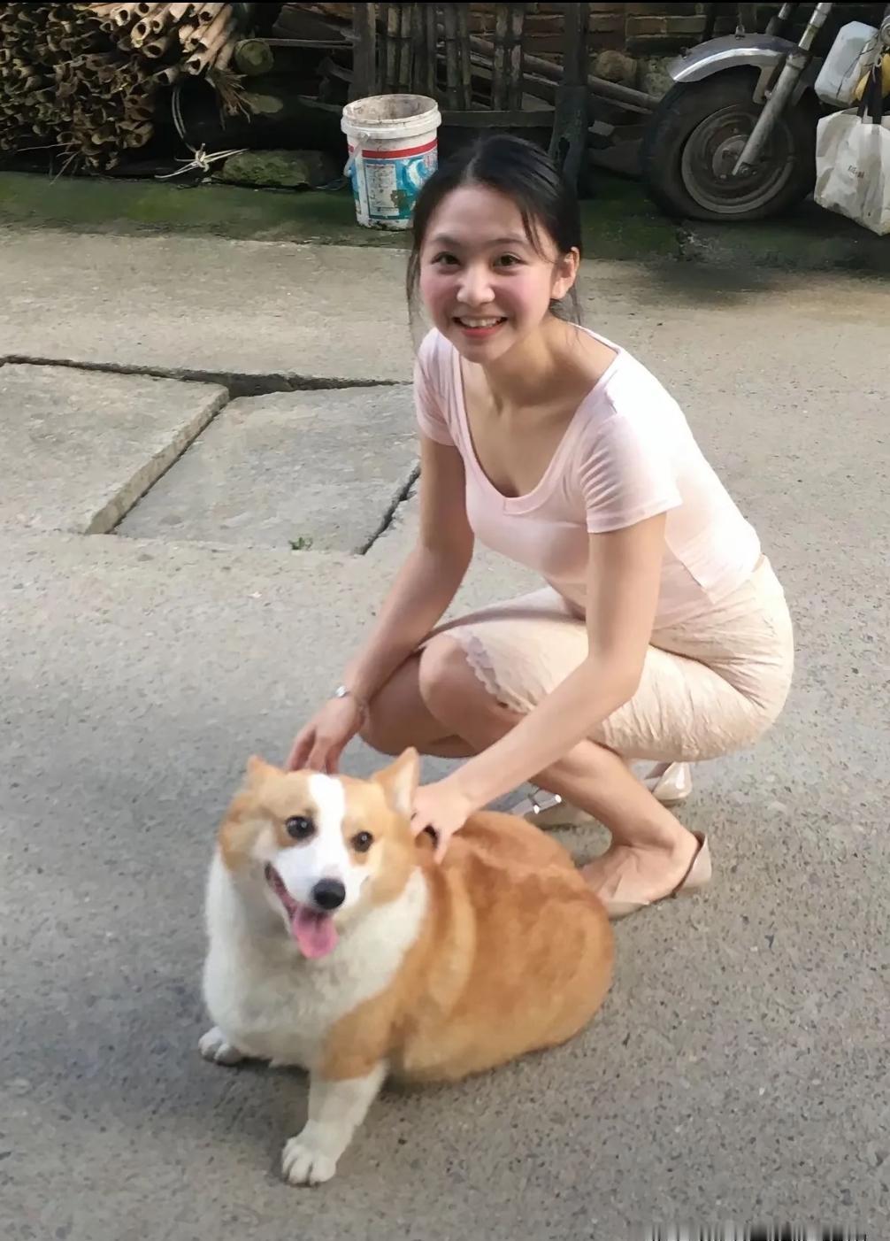 姑娘陪着可爱的柯基，笑容干净又灿烂。褪去城市的浮华，简单大方，没有距离感。她习