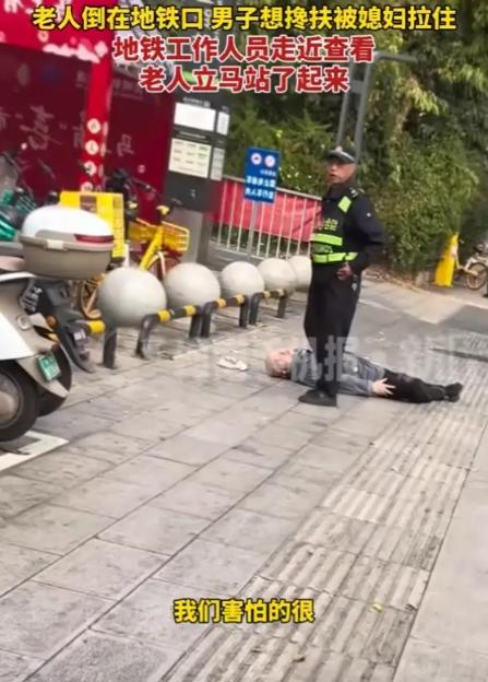 云南，男子见一老人一动不动躺在地铁口的地上，他想上前扶起老人，却被女友一把拉住，