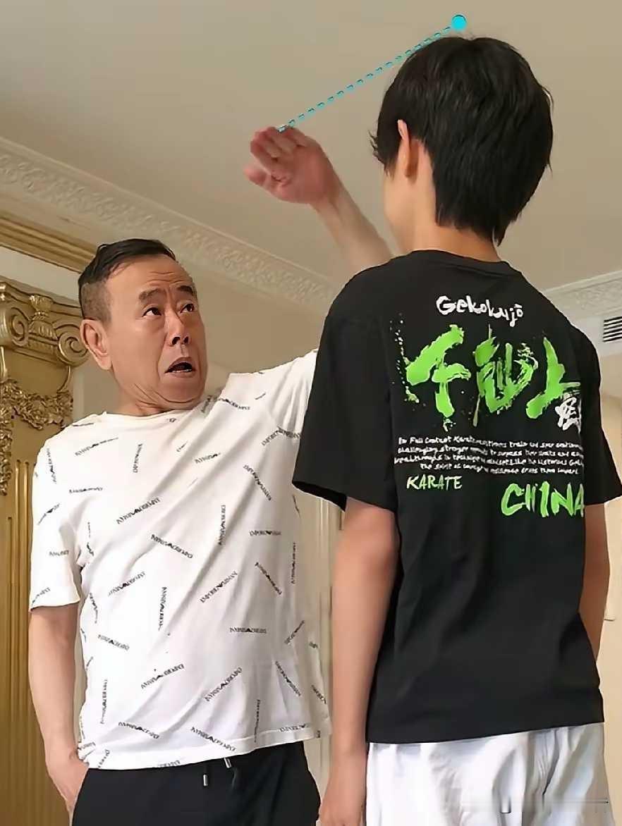 潘长江和外孙子比个头，小石头14岁了明显比姥爷高出好多，潘长江滑稽的表情，也是看
