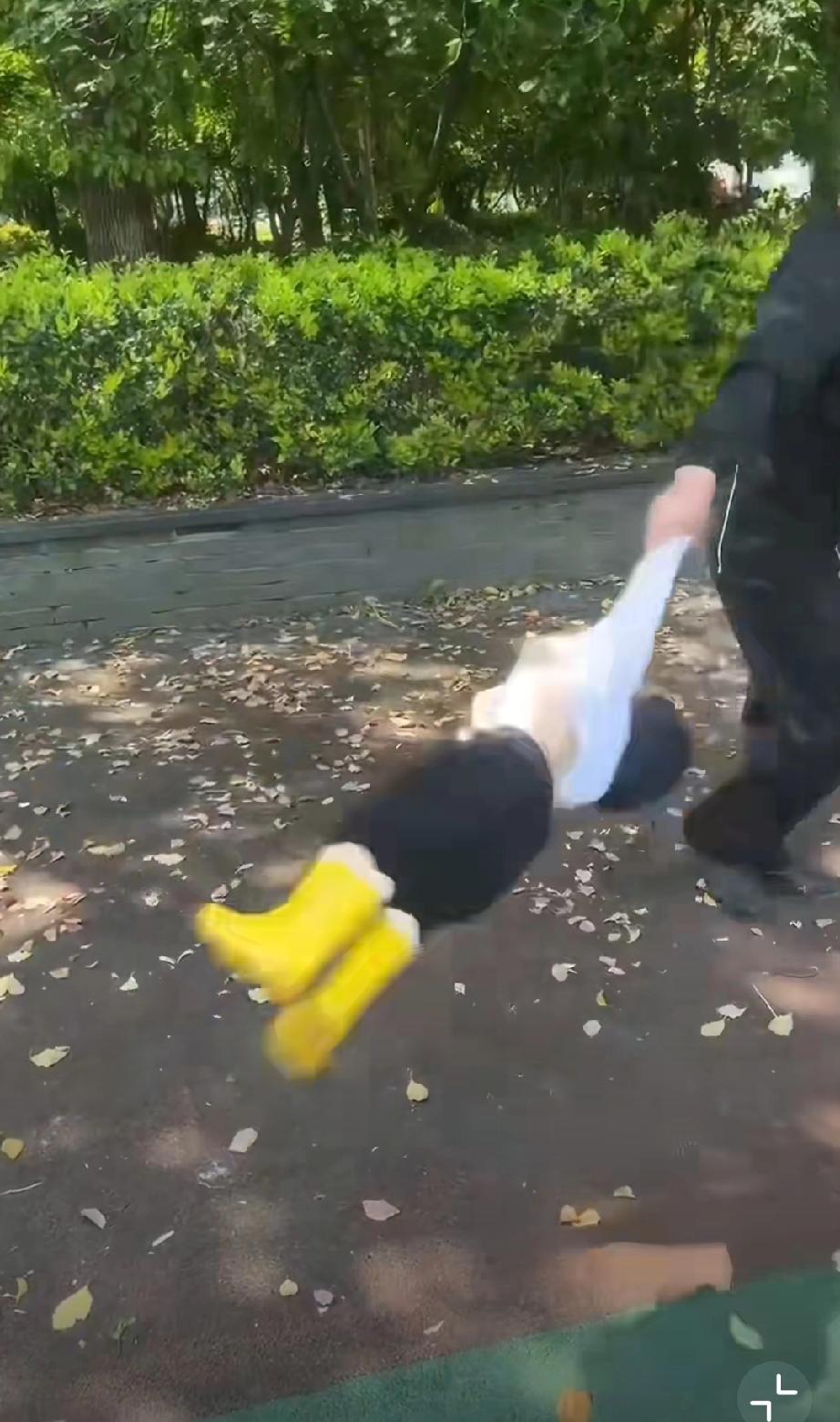 公园里，爷爷把孩子当“健身器材”一样甩来甩去，动作幅度极大。小女孩一直在喊“好了