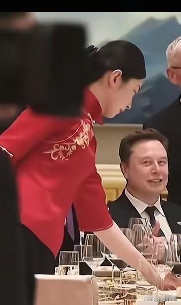 马斯克和宴会服务员的惊鸿一瞥女服务员身着红色中式旗袍，肤白貌美气质逼人，微笑刚