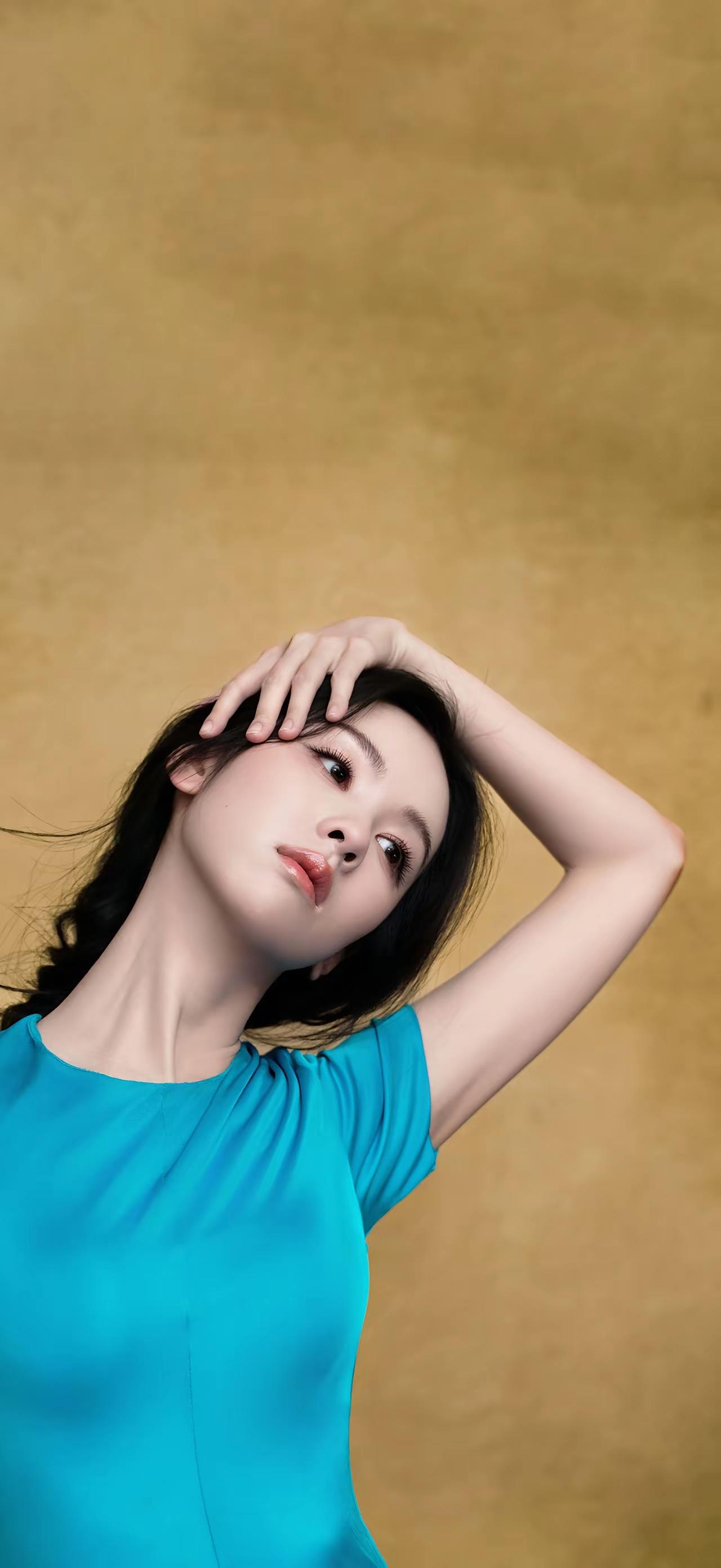 蓝衣美人倚，金光映玉颜。