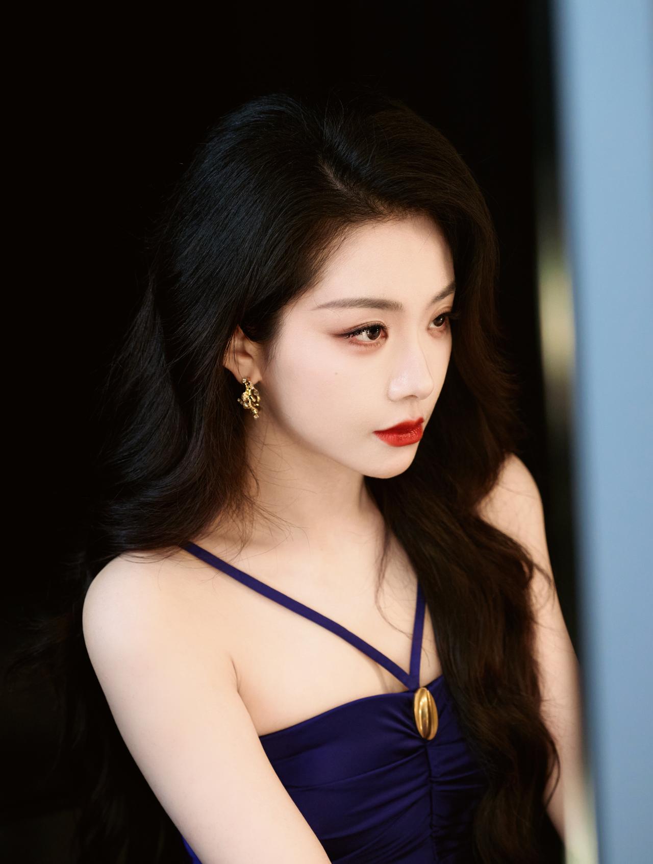 喻言藏蓝吊带裙勾勒出纤细腰肢，褶皱设计尽显细节质感。微卷长发随风轻扬，清冷又温