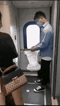 真聪明啊！火车上，一个小伙子没有买到坐票，他来到车厢连接处拿出一个白色口袋抖抖