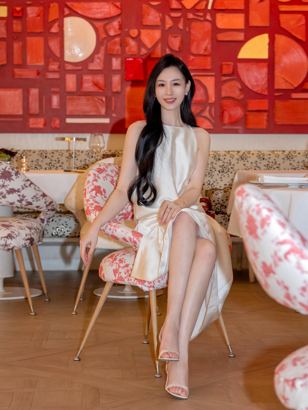 最让你心动的女人，是怎样的在暖调的餐厅里，以一袭米白缎面裙赴一场松弛之约，光影落