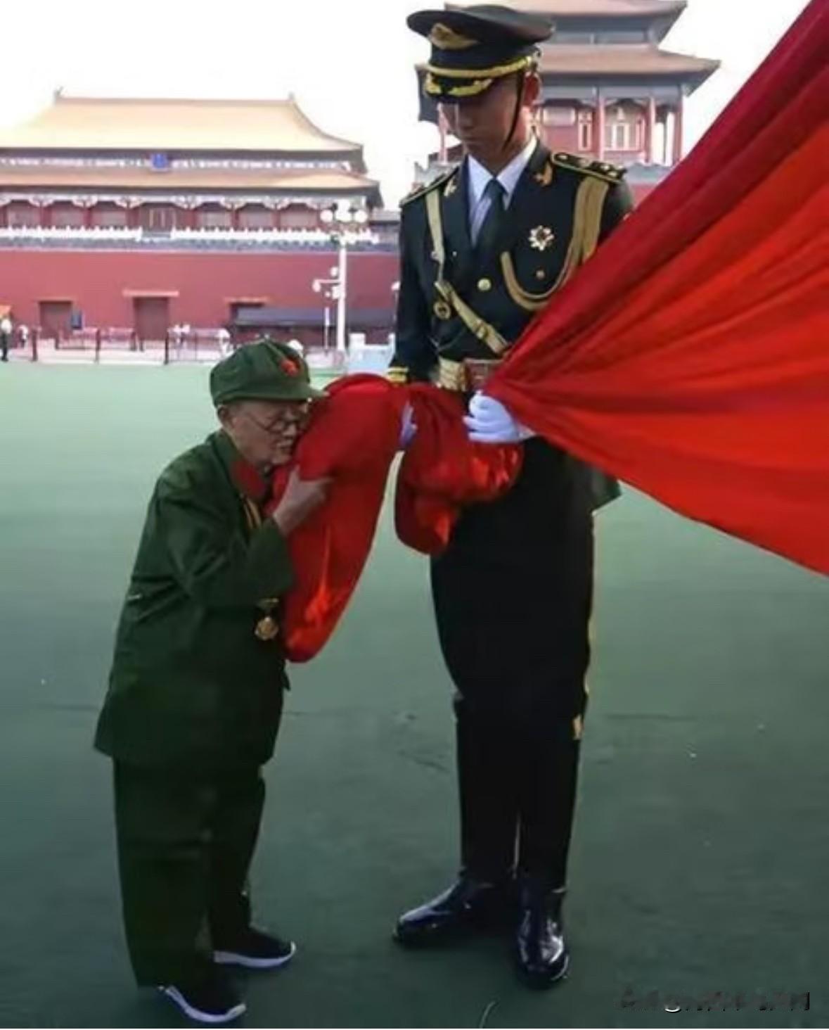 这是老英雄李甫安晚年在天安门广场，捧着鲜红的五星红旗亲吻的一张合影。李甫安身高只