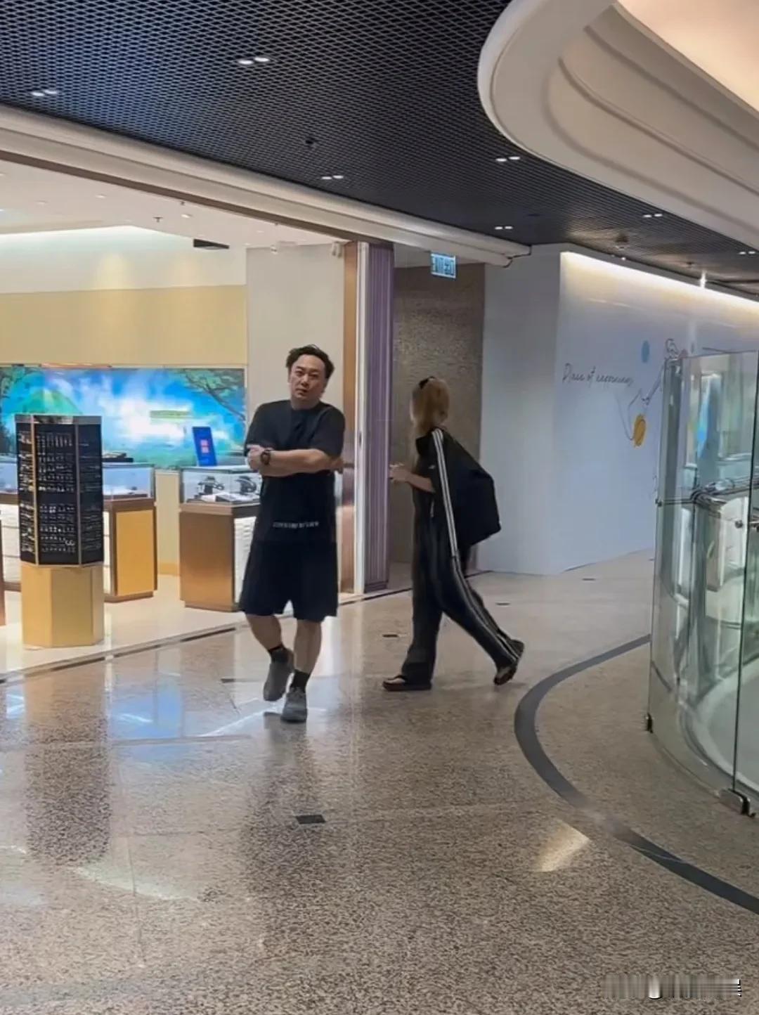陈奕迅和老婆徐濠萦现身香港时代广场逛街。陈奕迅一身短袖短裤，个子不高，比老婆徐