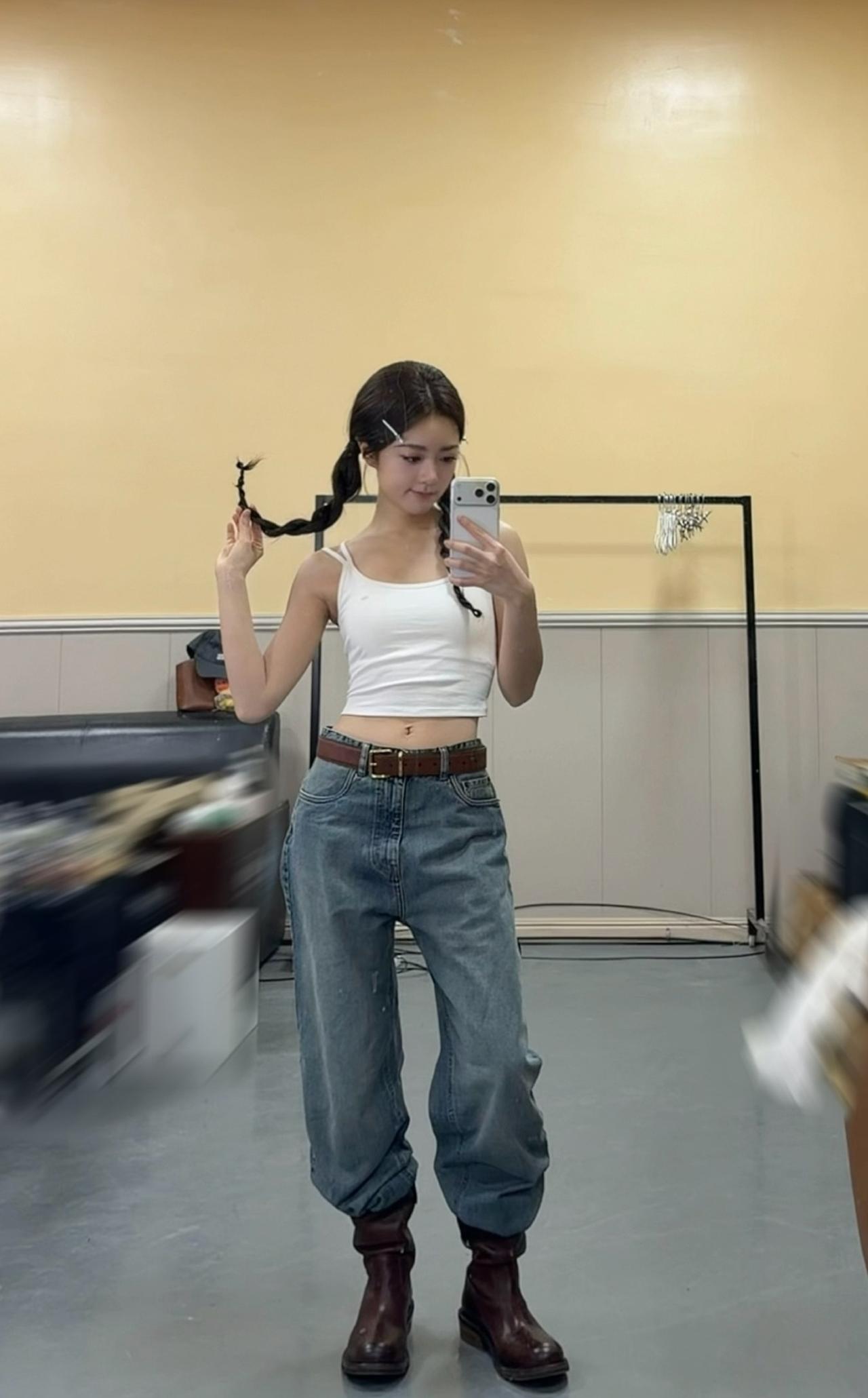 赵今麦对着镜头摆弄自己的双马尾。双麻花辫晃来晃去，甜妹感直接拉满，白色吊带配复