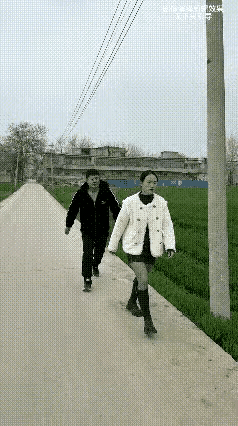 俩夫妻走在路上，为了点家庭琐事就争论不休。丈夫在后面，抬腿就给妻子的屁股上踢了一