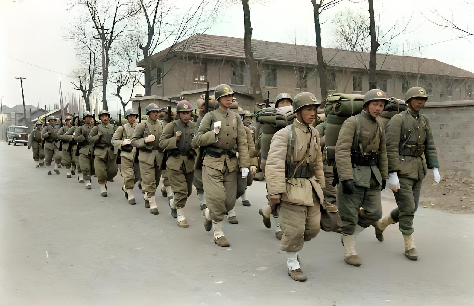 1949年，南京，一队国军士兵正穿过南京的街区，从他们的装备以及所带钢盔的帽徽来