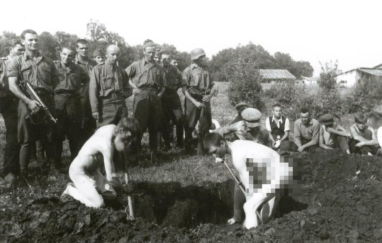 匈牙利军队强迫两名俄罗斯平民在被处决前挖掘自己的坟墓。（其中一个已经被迫脱光衣物