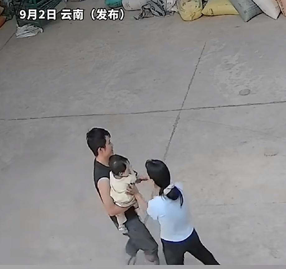 近日，云南曲靖。年轻的宝爸抱着宝宝，急着要去干活，叫旁边的宝妈把手中的宝宝抱走。