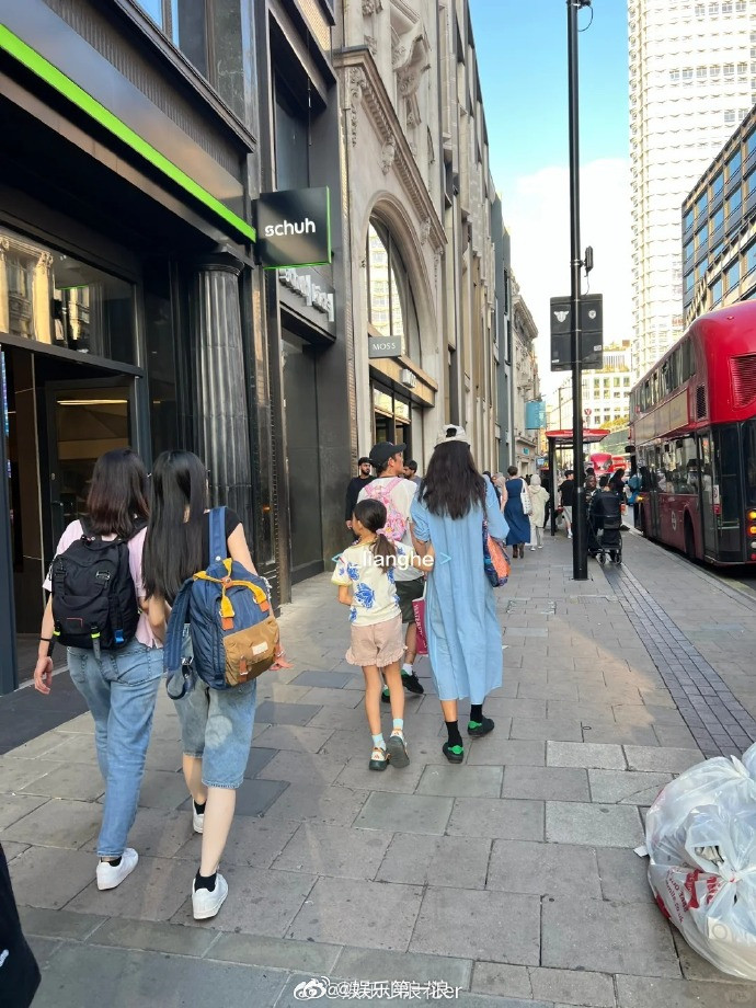 陈冠希帮女儿背书包有网友在伦敦偶遇陈冠希一家，陈冠希帮女儿背着粉色的小书包，温