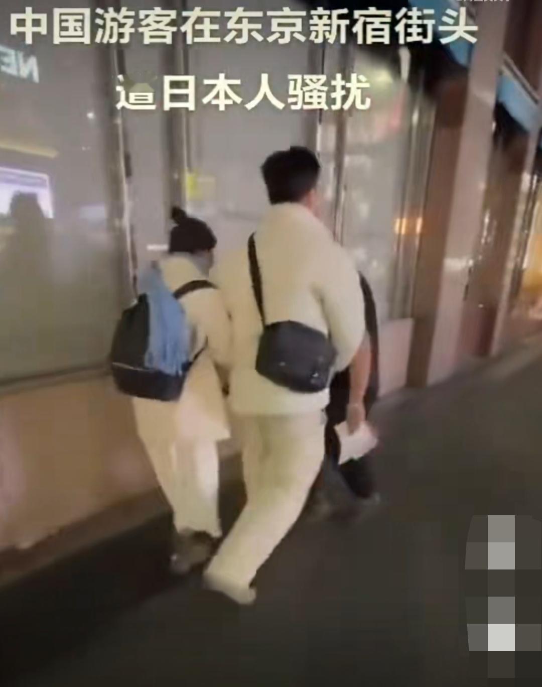 网上流出的一段视频:一对中国情侣在东京被几个日本人当街骚扰。其中一名男子体恤上印