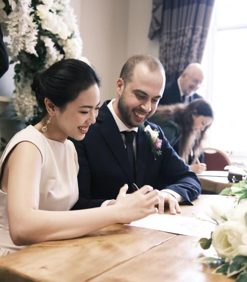 一位中国姑娘与英国男友喜结连理，脸上洋溢着幸福的微笑。她曾在国内从事外贸工作，与