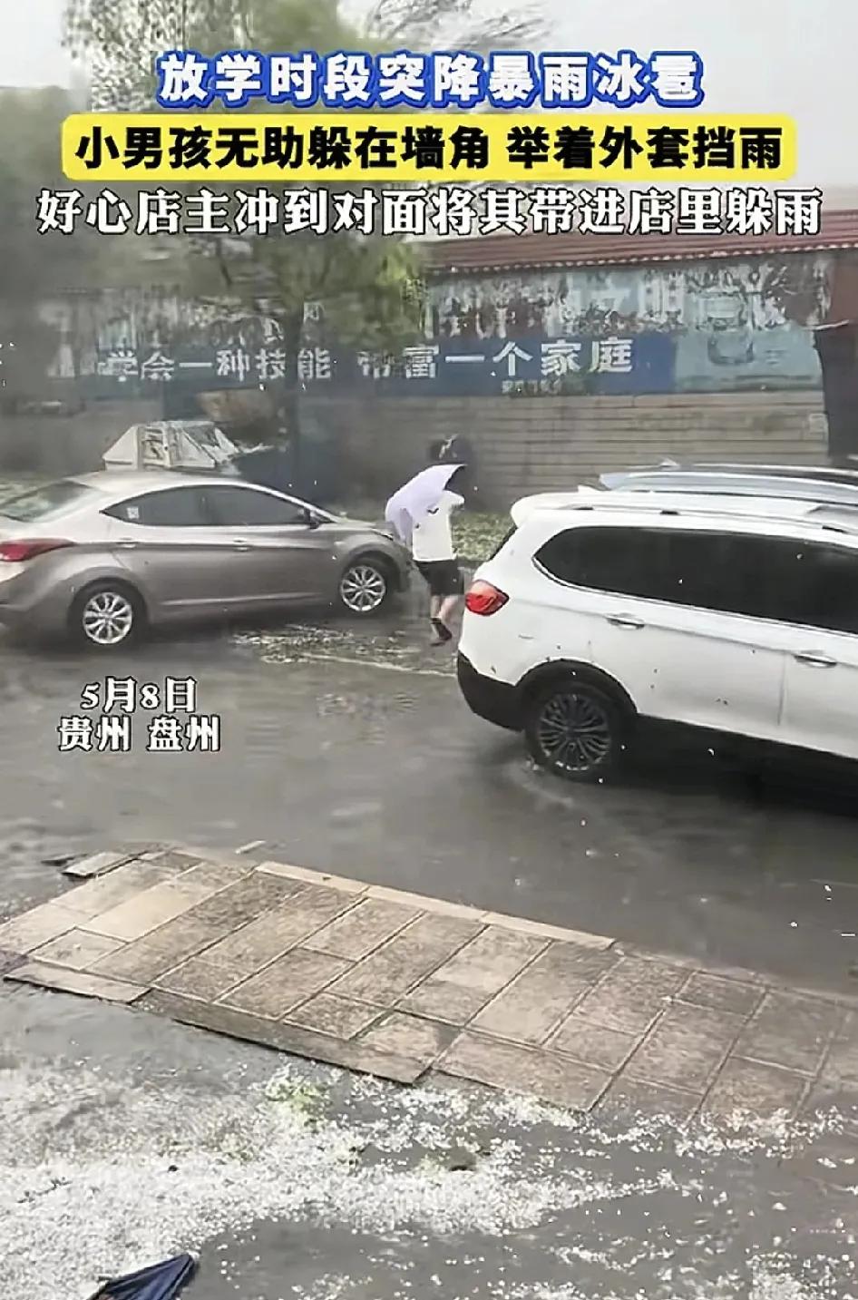 5月8日，贵州盘州，下课时间正好下冰雹，一名小男孩在路边用外套挡雨，吓得哇哇大哭