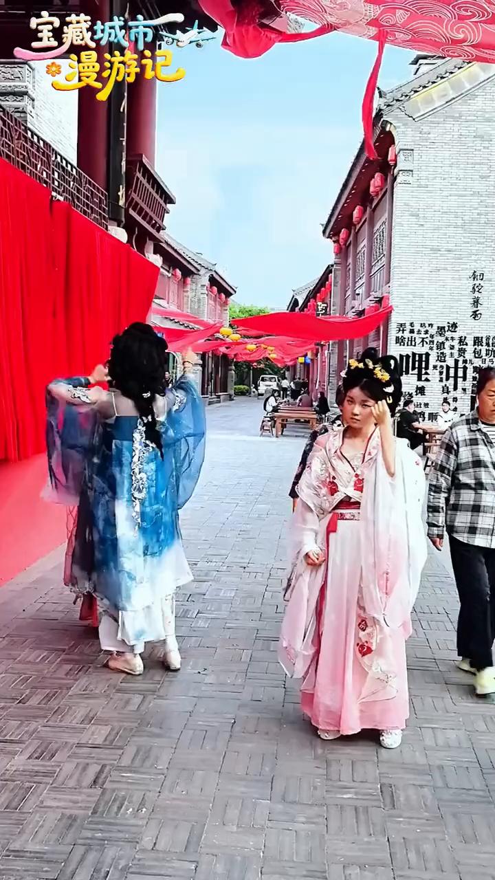 宝藏城市：铜驼暮雨。朋友们，这里是洛阳的铜驼暮雨景区。看我的身后有一个大的标牌