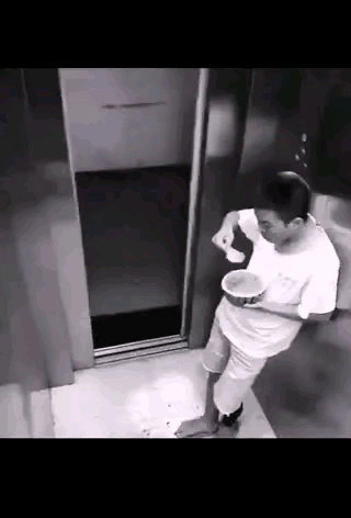 男子坐电梯下去的时候，手里捧着个西瓜，正在享受着西瓜的美味，谁知道下一秒就有人将