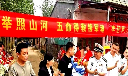 迎接英雄张伟出院回家的人群中，有一位身穿白色常服军装的军官，看起来应该是海军的常