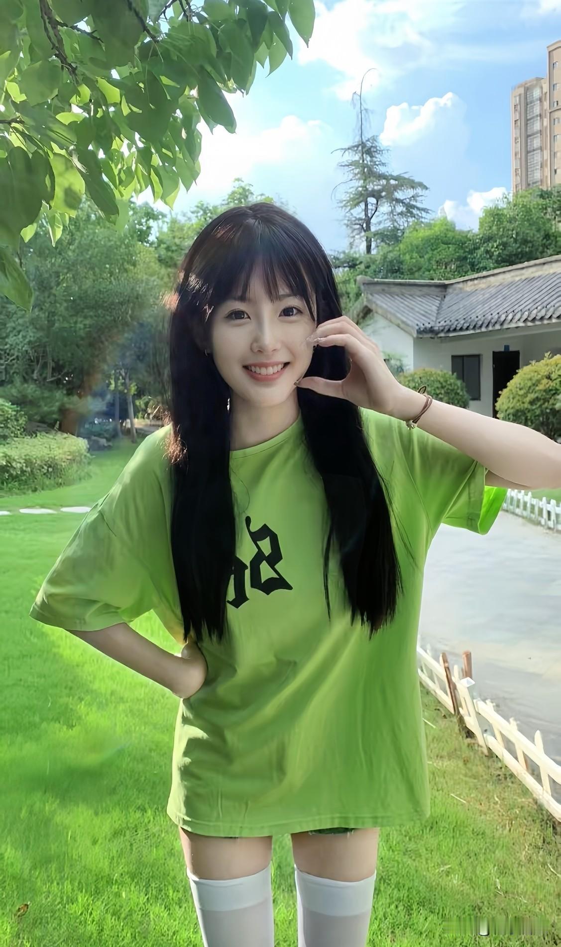 晴光正好的午后，绿意满盈的公园间，少女笑靥明媚，绿T恤配白袜清新撞色，满是鲜活的