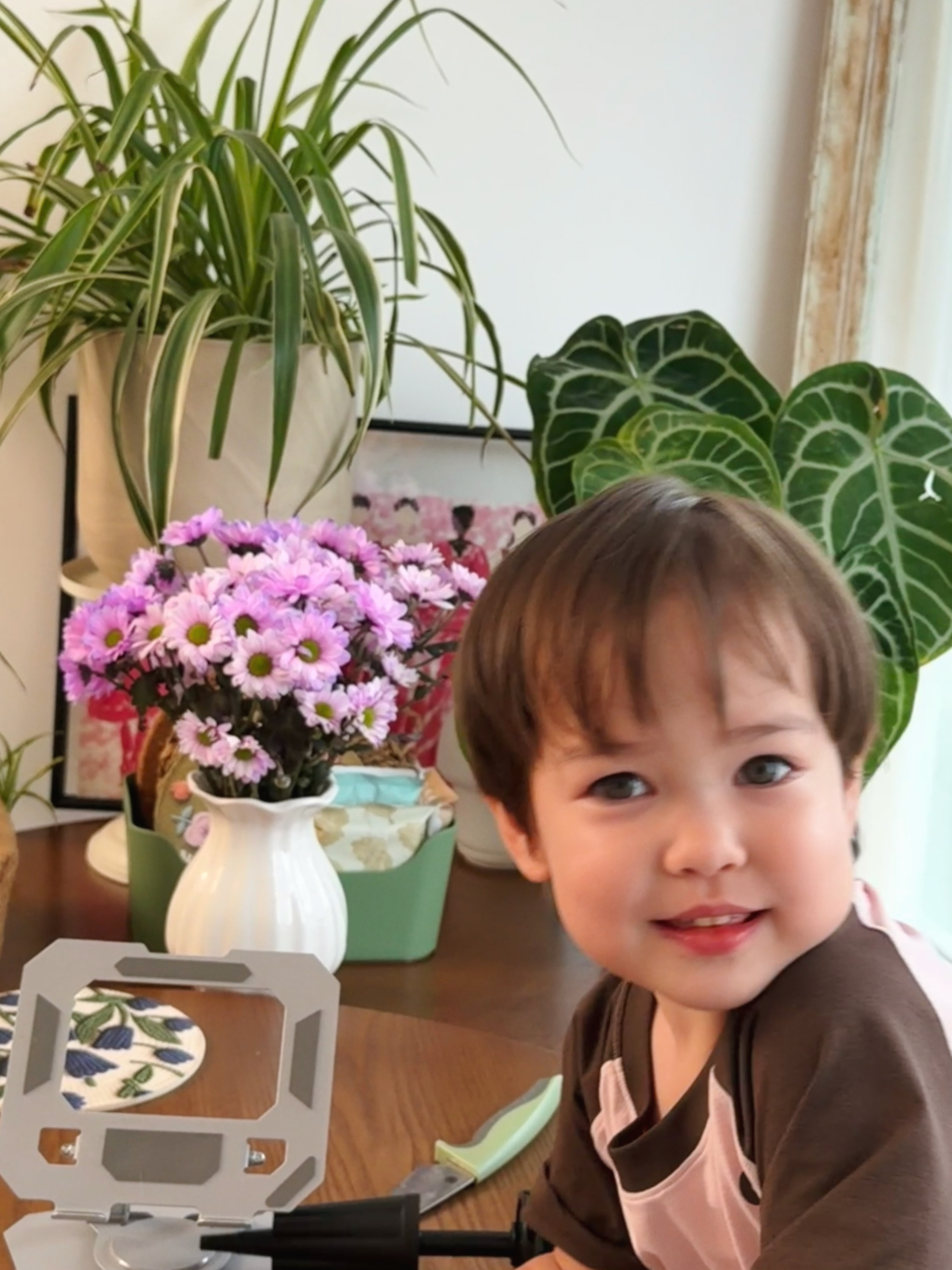 我在拍花，Yuni问我：“妈妈你在拍什么？”我说在拍很漂亮的东西呀！她马上把头伸
