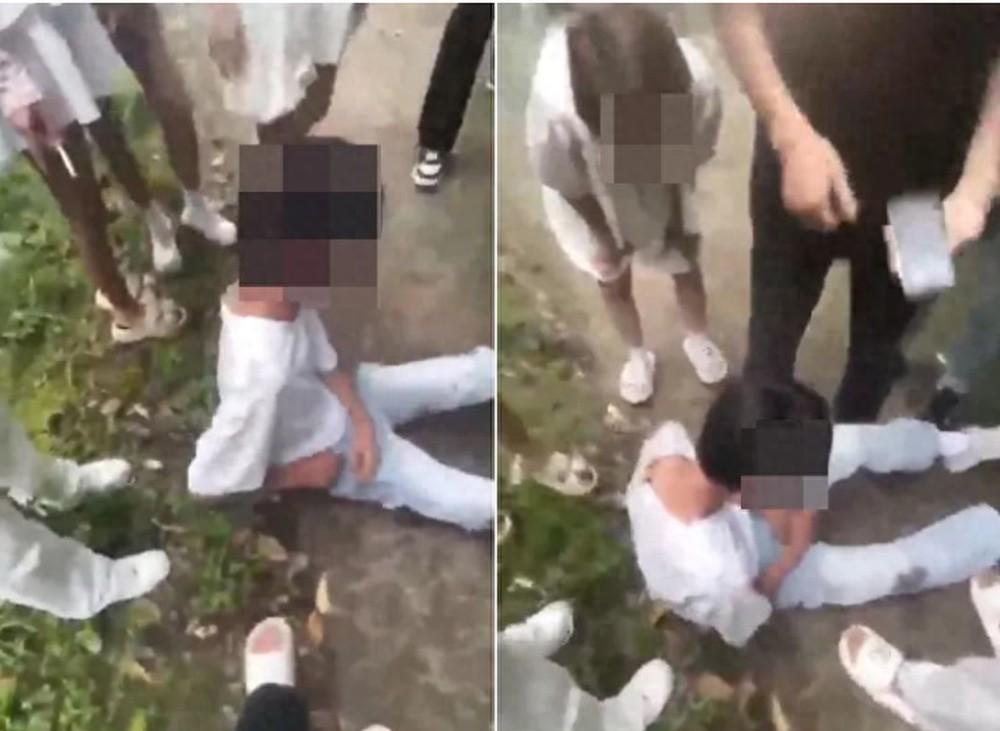 江西万载，一男孩遭到八九个同龄人的围殴，他跪地求饶但换来的是更长时间的殴打。短短