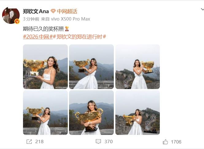 郑钦文夺冠后马不停蹄的赶往长城拍摄冠军写真身穿白色长裙，手里捧着冠军奖杯，站