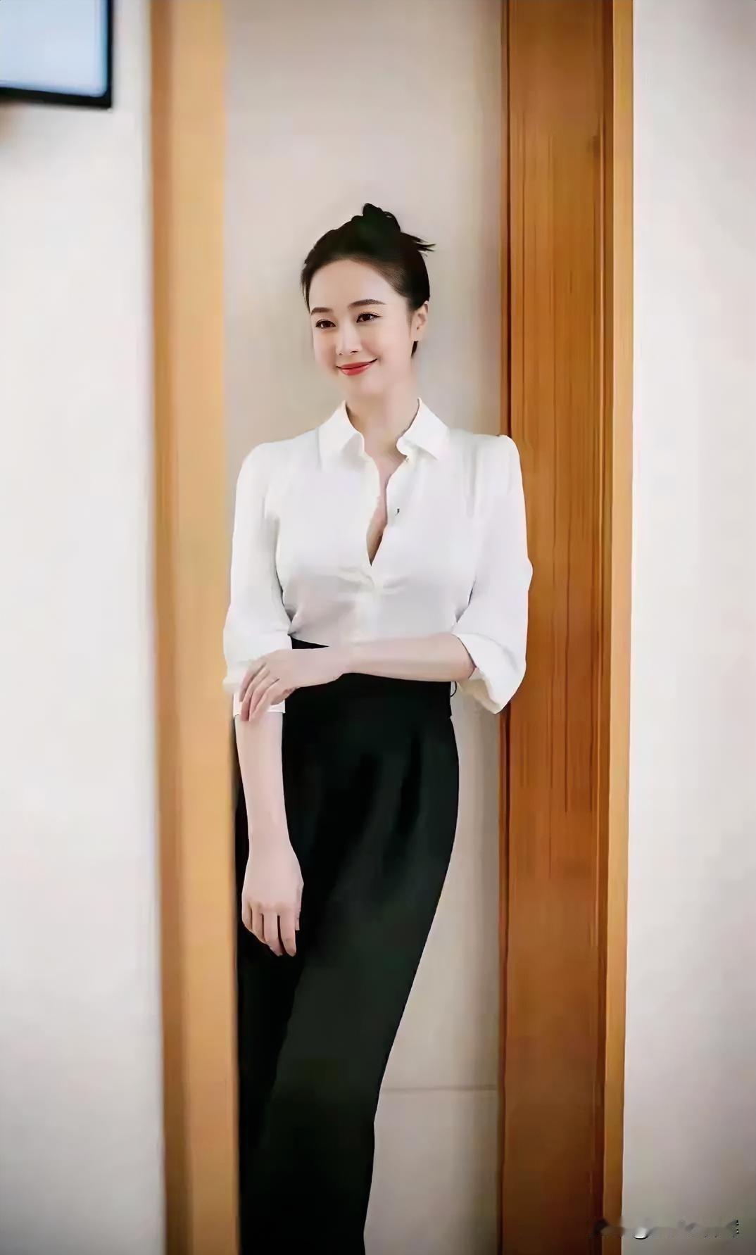 白衫黑裤，发髻轻挽，浅笑恬淡，气质温婉。