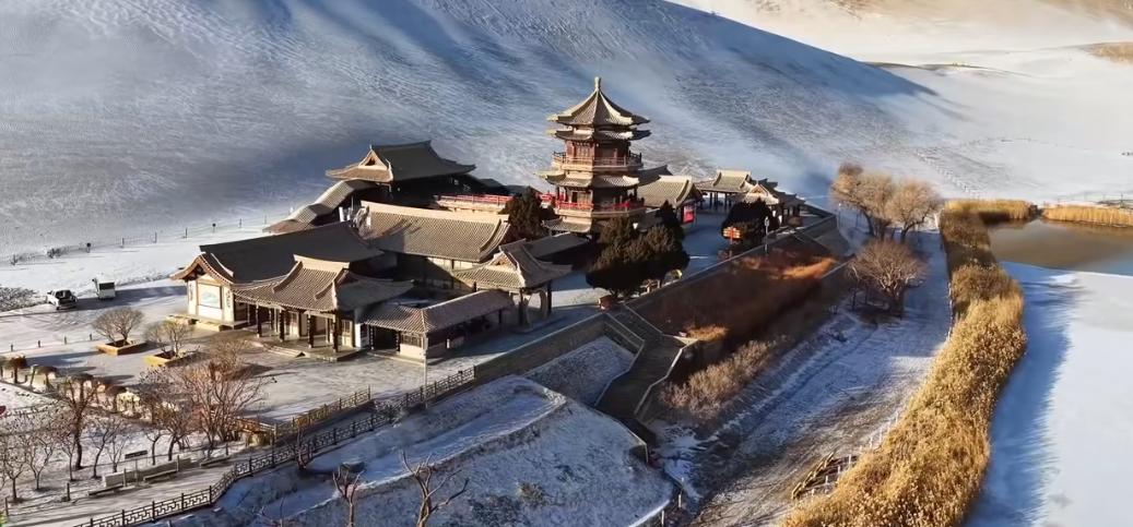 敦煌的冬天，总带着点神秘色彩。当金黄的沙丘突然披上银装，这座千年古城就像被施了魔