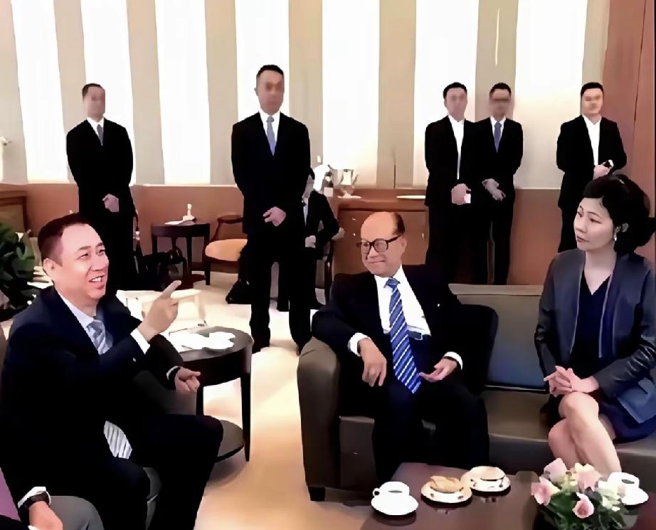 许家印和李嘉诚见面的一幕。李嘉诚身边坐着的是他的红颜知己周凯旋。许家印眉飞色