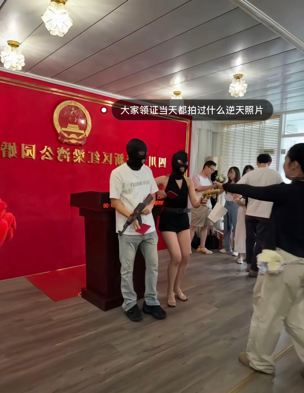 网友分享领证当天拍的逆天悍匪风格照片，夫妻二人戴着黑头套，还拿了一把AK47玩具