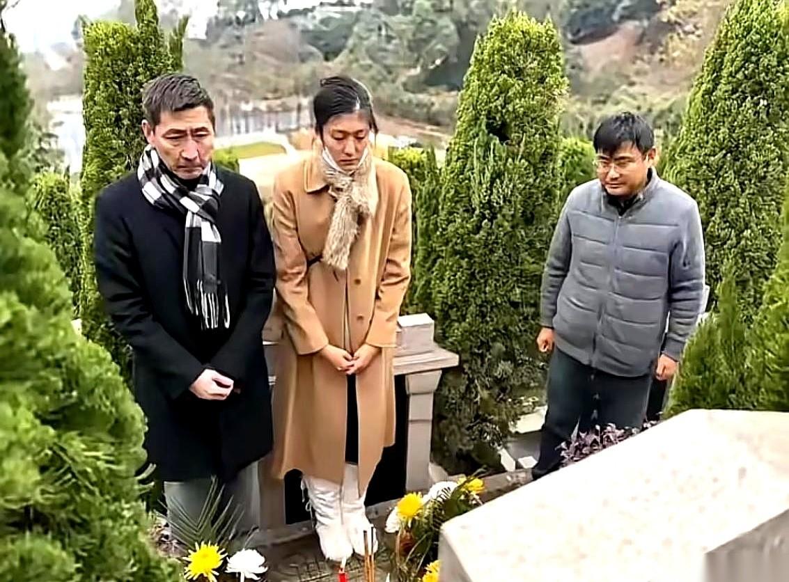 一张照片，演员张子健。他带着女儿，站在一座墓碑前。墓碑上，是他前妻李婷的名字。