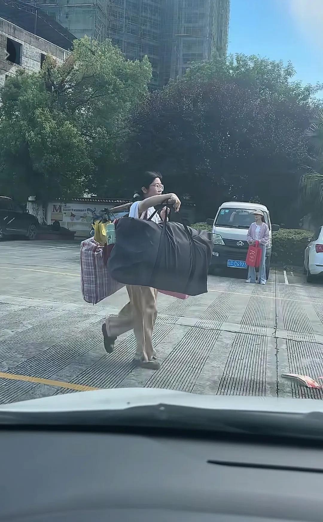 高考结束了，就应该像这位美丽动人大方得体的姑娘这个样子，一人挑着行李，非常自信的