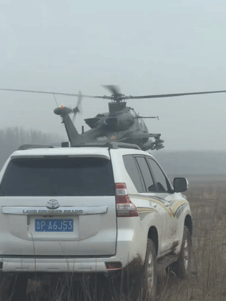 一男子开车在荒野上意外偶遇陆航直升机起降训练？当他的汽车从国产武装直升机旁边经